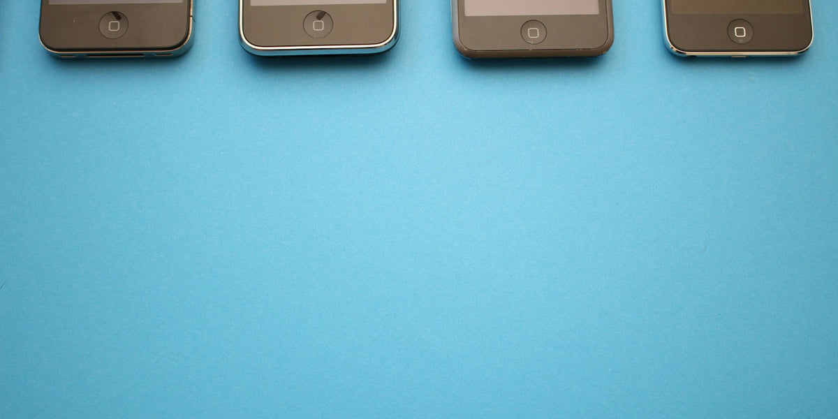 Several different smartphone models lined up together on a table